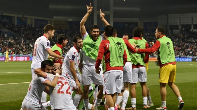 Para pemain timnas Tajikistan melakukan selebrasi gol kedua timnya pada pertandingan terakhir Grup A Piala Asia 2023 antara Tajikistan vs Lebanon di Stadion Jassim bin Hamad di Doha pada 22 Januari 2024.HECTOR RETAMAL / AFP.