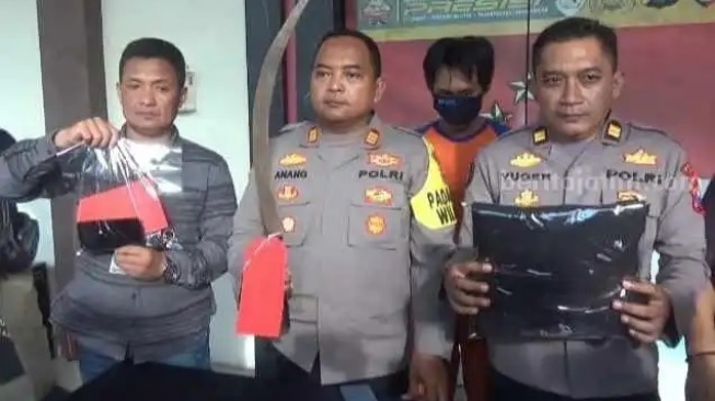 Polisi menunjukkan barang bukti senjata tajam yang digunakan anggota TGG. [Beritajatim.com]