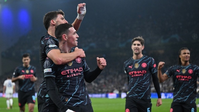 Para pemain Manchester City merayakan gol ke gawang FC Copenhagen pada laga babak 16 besar Liga Champions di Stadion Parken, Copenhagen, Denmark yang rampung Rabu (14/2/2024) dini hari WIB. [Jonathan NACKSTRAND / AFP]