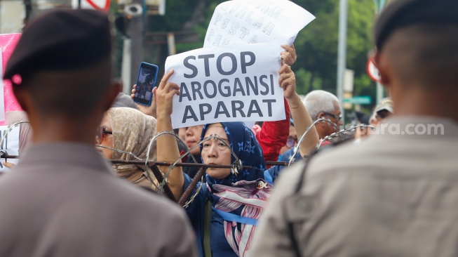 Massa dari Masyarakat Sipil Peduli Pemilu dan Demokrasi saat menggelar demo di depan Gedung Komisi Pemilihan Umum (KPU) RI, Jakarta, Jumat (16/2/2024). [Suara.com/Alfian Winanto]