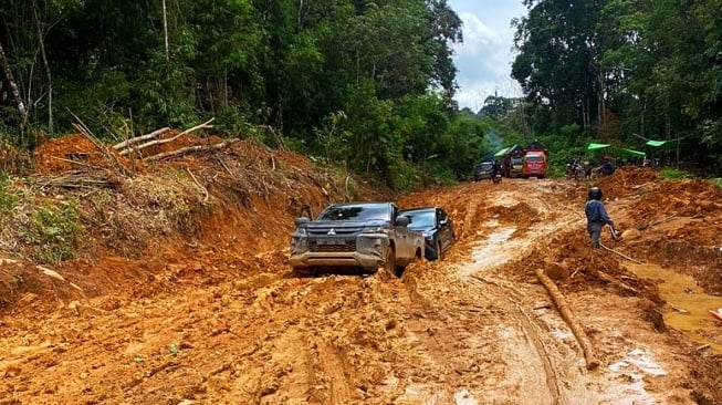 Kendaraan roda empat mencoba melintasi jalan provinsi Titi-Tanjung. (Istimewa)