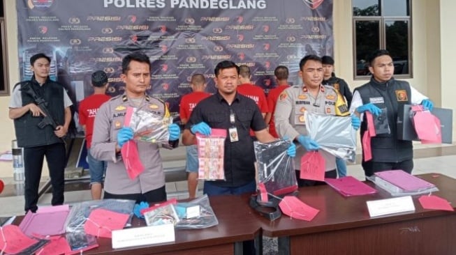 Wakapolres Pandeglang didampingi Kasat Reskrim menunjukkan barang bukti kasus pembobol rumah warga Pandeglang yang menggasak uang tunai ratusan juta, laptop dan sejumlah barang berharga lainnya. [IST/Bantennews].