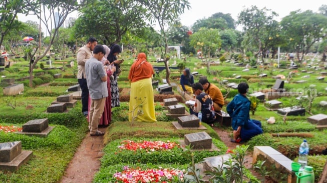 Warga melakukan ziarah kubur di TPU Karet Bivak, Jakarta, Minggu (10/3/2024). [Suara.com/Alfian Winanto]