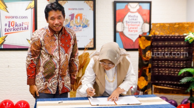 Pemimpin Redaksi Suara.com, Suwarjono (kiri) bersama Founder & Researcher CORE Indonesia, Hendri Saparini (kanan) saat menandatangani MoU Kerja Sama gelaran Youth Economic Summit 2024 di Kantor Redaksi Suara.com, Kuningan, Jakarta, Rabu (13/3/2024). [Suara.com/Alfian Winanto]