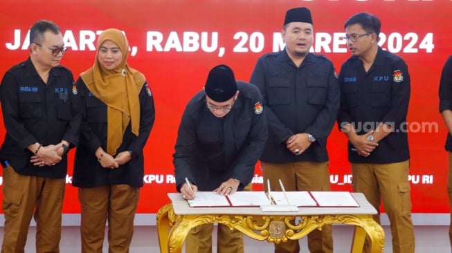 Ketua KPU Hasyim Asy'ari (tengah) menandatangani Berita Acara Hasil Pemilu 2024 saat Rapat Pleno Terbuka Penetapan Hasil Pemilu 2024 Tingkat Nasional di Kantor KPU RI, Jakarta, Rabu (20/3/2024). [Suara.com/Alfian Winanto]