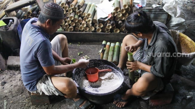 Pekerja menyelesaikan produksi lemang di kawasan Senen, Jakarta, Sabtu (23/3/2024). [Suara.com/Alfian Winanto]