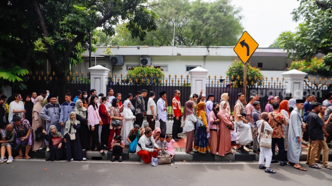 Sejumlah warga mengantre untuk menghadiri open house yang diselenggarkan Presiden Joko Widodo di depan Kantor Kementerian Sekretariat Negara, Jakarta, Rabu (10/4/2024). [Suara.com/Alfian Winanto]