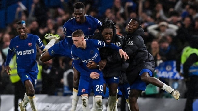 Gelandang Chelsea, Cole Palmer (tengah) melakukan selebrasi bersama rekan satu timnya setelah mencetak gol keempat selama pertandingan pekan ke-33 Liga Inggris 2023-2024 antara Chelsea vs Manchester United di Stamford Bridge di London pada 4 April 2024.Glyn KIRK / AFP.