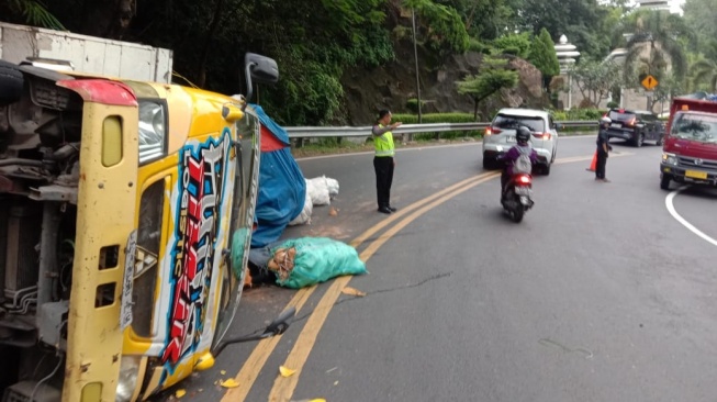 Truk Over Muatan Batok Kelapa Terguling Usai Tak Kuat Melibas Tanjakan di Tikungan Slumprit