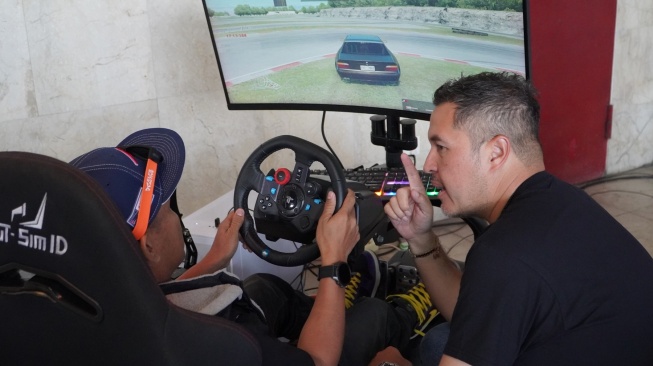 Pembalap nasional Rifat Sungkar sedang memberikan pelatihan di simulator untuk jurnalis yang mengikuti acara Pertamina Fastron Drifting Experience di Sentul, Bogor, Senin (29/4/2024). [Dok Pertamina Lubricants]