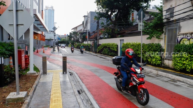 Warga berjalan melewati kawasan Transport Hub Dukuh Atas, Jakarta, Selasa (30/4/2024). [Suara.com/Alfian Winanto]