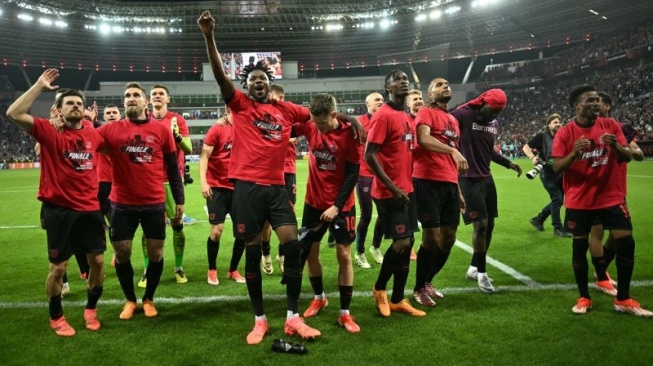 Para pemain Bayer Leverkusen merayakan keberhasilan mereka mencapai final Liga League setelah menyingkirkan AS Roma dengan menahan seri mereka dalam leg kedua semi final di Leverkusen pada 9 Mei 2024. (AFP/INA FASSBENDER)