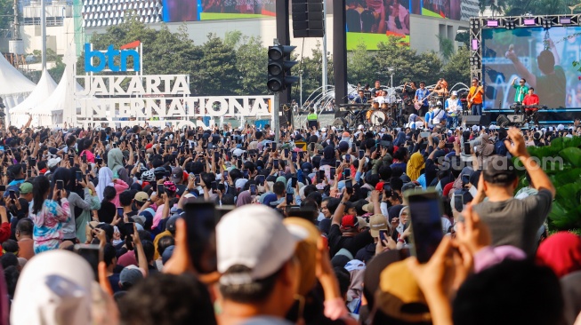 Grup musik Kahitna tampil menghibur warga saat Hari Bebas Kendaraan Bermotor (HBKB) di Bundaran HI, Jakarta, Minggu (19/5/2024). [Suara.com/Alfian Winanto]