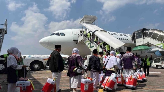 Sejumlah jamaah calon haji Kloter 18 Embarkasi Solo, di Solo, Jawa Tengah, Kamis (16/5/2024), mengantre memasuki pesawat Garuda Indonesia di Bandara Adi Soemarmo Solo menuju Bandara Amir Muhammad bin Abdul Aziz (AMAA), Madinah. (ANTARA/Harianto)