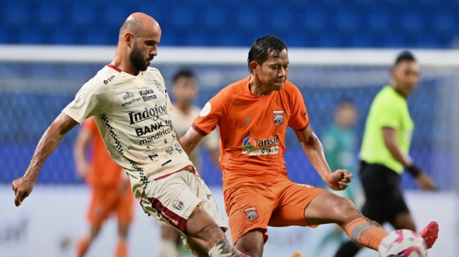 Gelandang Borneo FC, Adam Alis (kanan) berebut bola dengan gelandang Bali United, Mohammed Rashid dalam laga perebutan tempat ketiga BRI Liga 1 2023-2024 di Stadion Batakan, Balikpapan, Kamis (30/5/2024) malam WIB. [Dok. Borneo FC]