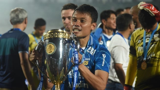 Dedi Kusnandar berpose dengan trofi Liga 1 usai Persib Bandung mengalahkan Madura United di partai final Championship Series pada 31 Mei 2024 di Stadion Gelora Bangkalan. [Foto: Persib]