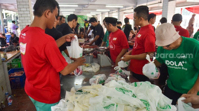 Sejumlah petugas memotong daging hewan kurban di halaman Masjid Istiqlal, Jakarta, Selasa (18/6/2024). [Suara.com/Alfian Winanto]