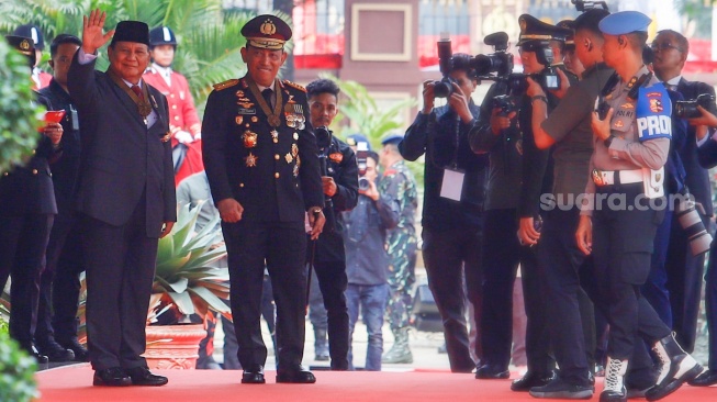 Menteri Pertahanan dan Presiden Terpilih Prabowo Subianto (kiri) didampingi Kapolri Jenderal Pol Listyo Sigit Prabowo (kanan) menyapa awak media di Mabes Polri, Jakarta, Kamis (20/6/2024). [Suara.com/Alfian Winanto]