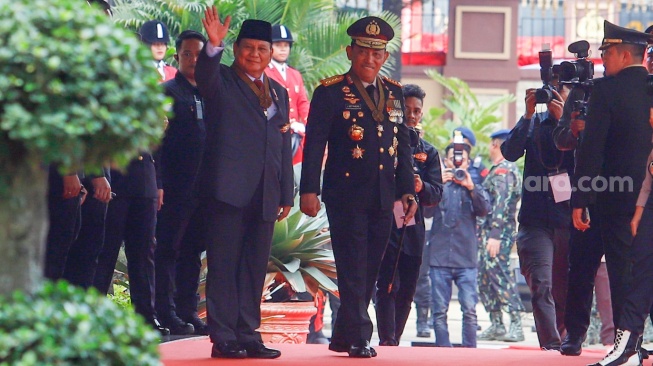 Menteri Pertahanan dan Presiden Terpilih Prabowo Subianto (kiri) didampingi Kapolri Jenderal Pol Listyo Sigit Prabowo (kanan) menyapa awak media di Mabes Polri, Jakarta, Kamis (20/6/2024). [Suara.com/Alfian Winanto]