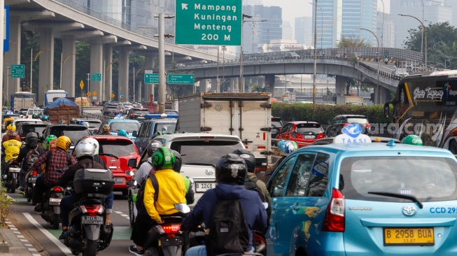 Sejumlah kendaraan melintas di kawasan Gatot Subroto, Jakarta, Senin (24/6/2024). [Suara.com/Alfian Winanto]