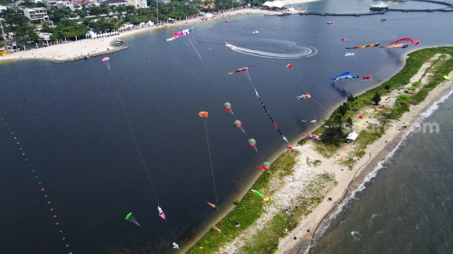 Gambar udara peserta menerbangkan layang-layang saat mengikuti Festival Layang-layang Internasional 2024 di Pantai Lagoon, Taman Impian Jaya Ancol, Jakarta, Kamis (4/7/2024). [Suara.com/Alfian Winanto]