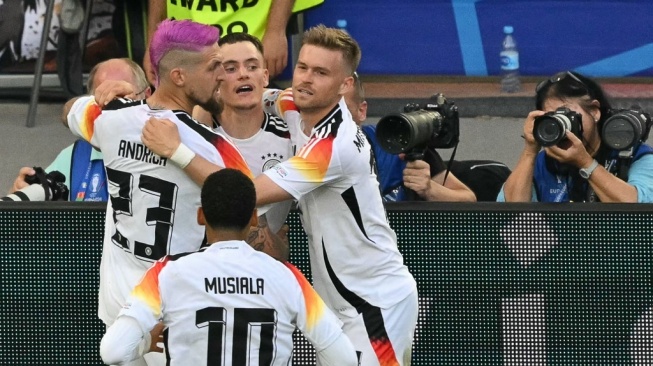 Gelandang Jerman Florian Wirtz (tengah) merayakan bersama rekan satu timnya setelah mencetak gol pertama timnya pada pertandingan sepak bola perempat final UEFA Euro 2024 antara Spanyol dan Jerman di Stuttgart Arena di Stuttgart pada 5 Juli 2024.MIGUEL MEDINA / AFP