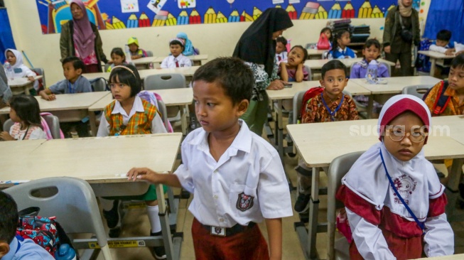 Sejumlah siswa ditemani orang tuanya saat menjalani Masa Pengenalan Lingkungan Sekolah (MPLS) di Sekolah Dasar Negeri (SDN) 01 & 03 Kramat, Jakarta, Senin (8/7/2024). [Suara.com/Alfian Winanto]