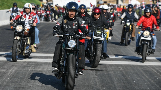 Presiden Joko Widodo (depan) bersama Menteri PUPR yang juga Plt Kepala Ototiratas IKN Basuki Hadimuljono (kedua kanan) dan Wakil Menteri ATR yang juga Wakil Kepala Otoritas IKN Raja Juli Antoni (kanan) serta sejumlah influencer media sosial mengendarai motor melewati Jalan Tol IKN di Balikpapan, Kalimantan Timur, Minggu (28/7/2024). [ANTARA FOTO/Hafidz Mubarak A/Spt]