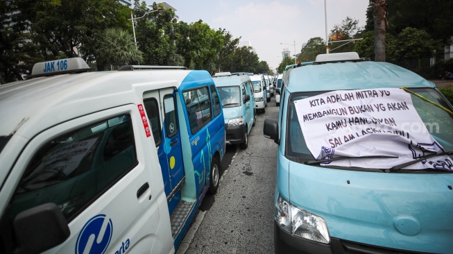 Kelompok sopir Mikrotrans atau angkot Jaklingko dan Mikrolet Jakarta melakukan aksi demonstrasi di depan Balai Kota DKI Jakarta, Selasa (30/7/2024). [Suara.com/Alfian Winanto]