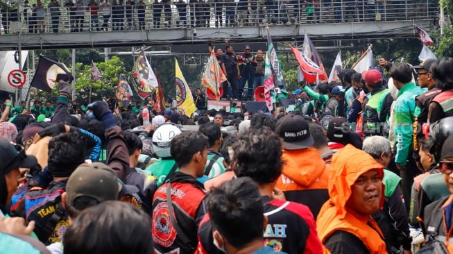 Massa pengemudi ojek online atau ojek daring berunjuk rasa di kawasan Patung Kuda, Jakarta, Kamis (29/8/2024). [Suara.com/Alfian Winanto]