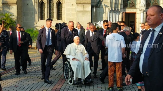 Sri Paus Fransiskus memperhatikan tulisan dan kaus penampil bergambarkan dirinya [Suara.com/CNR ukirsari]