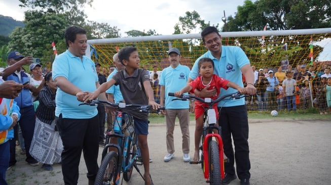 Rendi Sitanggang (8) dapat hadiah sepeda usai membobol gawang Bobby Nasution. [Ist]