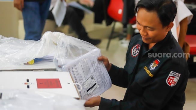 Petugas mengecek logistik Pilkada sebelum pendistribusian di Kantor Kecamatan Makasar, Jakarta, Selasa (26/11/2024). [Suara.com/Alfian Winanto]