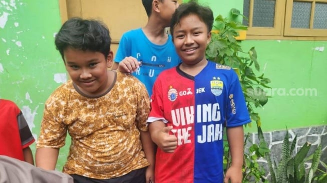 Bocah berjersey Jakmania-Viking saat ditemui Ridwan Kamil jelang nyoblos Pilkada Jawa Barat.  (Suara.com/Fakhri)