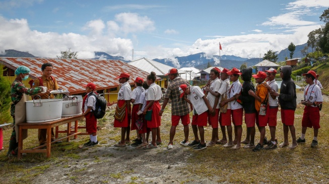 Siswa mengantre untuk mendapatkan menu makan bergizi gratis perdana di SD Santo Michael Bilogae, Distrik Sugapa, Kabupaten Intan Jaya, Papua Tengah, Senin (20/1/2025). [ANTARA FOTO/Martinus Eguay/app/tom]