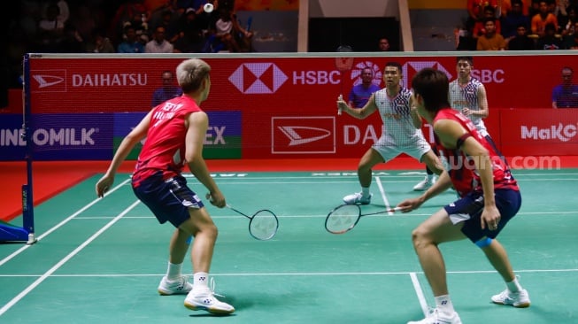 Pebulu Tangkis Ganda Putra Indonesia, Fajar Alfian dan Muhammad Rian Ardianto saat melawan Pebulu Tangkis Ganda Putra Malaysia Man Wei Chong dan Kai Wun Tee menunjukan medali dan piala usai pertandingan final Daihatsu Indonesia Masters 2025 di Istora Senayan, Jakarta, Minggu (26/1/2025). [Suara.com/Alfian Winanto]