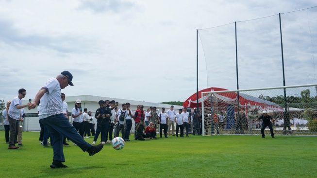 Kepala Otorita Ibu Kota Nusantara (OIKN) Basuki Hadimuljono (kiri) menendang bola saat mengunjungi pembangunan Training Center PSSI pada kegiatan Nusantara International Partner Visit (NIPV) di Ibu Kota Nusantara (IKN), Penajam Paser Utara, Kalimantan Timur, Jumat (14/2/2025).  [ANTARA FOTO/Aditya Nugroho/mrh/tom]