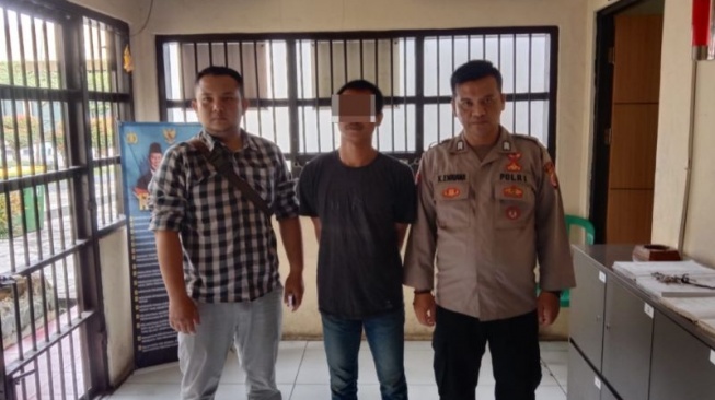 Petugas kepolisian mengamankan tersangka pemilik senjata api rakitan VR (tengah) di Rumah Tahanan Polres Garut, Jawa Barat, Sabtu (15/2/2025). ANTARA/HO-Polres Garut.