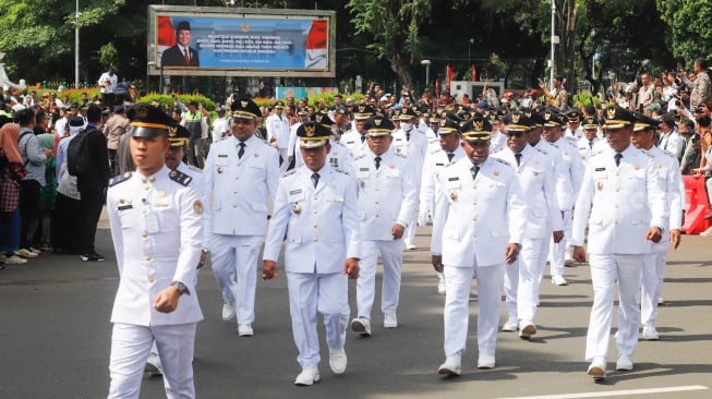 Ratusan kepala daerah terpilih dari gubernur, wali kota dan bupati berjalan beriringan dari Monumen Nasional menuju Istana Merdeka, Jakarta, Kamis (20/2/2025). [Suara.com/Alfian Winanto]