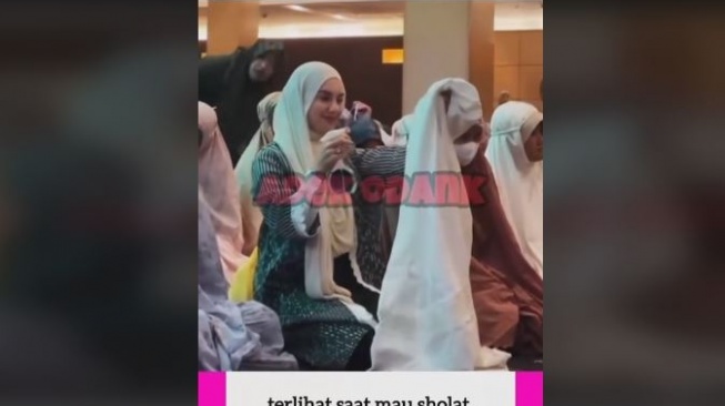 Irish Bella semprot pewangi ke mukena. [TikTok]