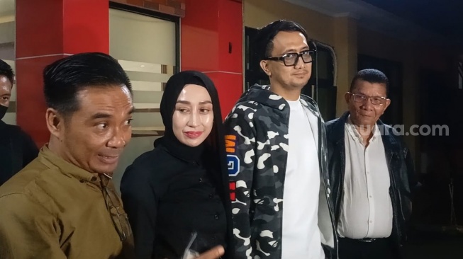 Julianus P. Sembiring (Pengacara Reza Gladys berbaju cokelat), Reza Gladys dan suaminya, Attaubah Mufid di Polres Metro Jakarta Selatan, Kamis (6/3/2025). [Suara.com/Rena Pangesti]