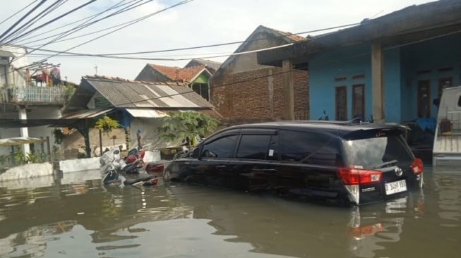 Situasi tampak rumah hingga mobil terendam banjir akibat Sungai Cikapundung yang meluap di Kabupaten Bandung, Jawa Barat, Minggu (9/3/2025). (ANTARA/Rubby Jovan)