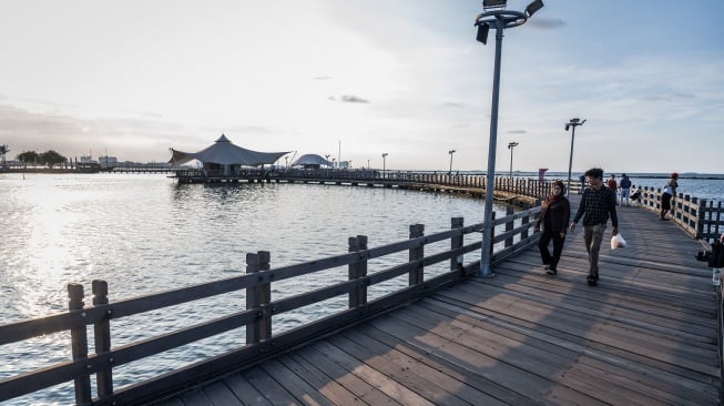 Warga berjalan di Le Bridge, Taman Impian Jaya Ancol, Jakarta, Sabtu (1/3/2025). PT Pembangunan Jaya Ancol Tbk menggratiskan tiket masuk bagi masyarakat yang ingin berbuka puasa dan ngabuburit di kawasan Ancol selama bulan Ramadhan 1446 Hijriah mulai pukul 17.00 WIB hingga 23.00 WIB pada periode 1 Maret hingga 28 Maret 2025. ANTARA FOTO/Bayu Pratama S/YU