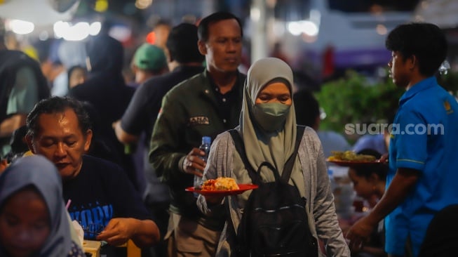 Pengunjung memilih menu berbuka puasa di Sentra kuliner Nasi Kapau di Jalan Kramat Raya, Senen, Jakarta, Selasa (18/3/2025). [Suara.com/Alfian Winanto]
