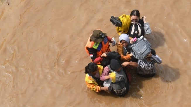 Ilustrasi - Warga melintasi banjir di kawasan Cililitan, Jakarta, Selasa (4/3/2025). ANTARA FOTO/Akbar Nugroho Gumay/agr.