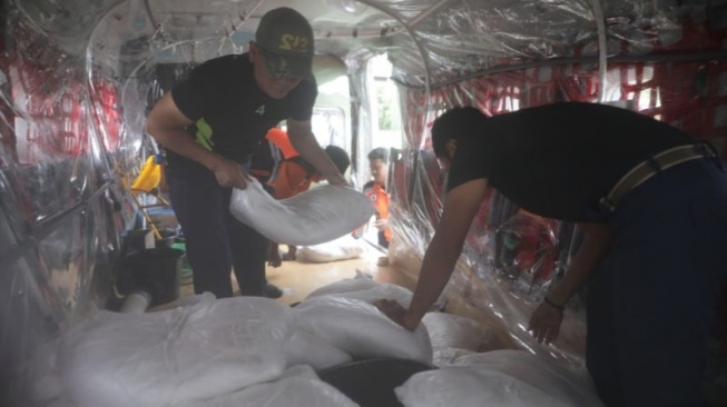 Petugas mengangkut bahan semai saat akan diterbangkan untuk modifikasi cuaca di Jakarta, Senin (17/3/2025). (foto dok. BPBD DKI Jakarta)