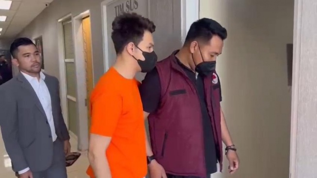 Potret Jonathan Frizzy pakai baju tersangka kasus penyalahgunaan obat keras lewat media vape. (Dok. Istimewa)