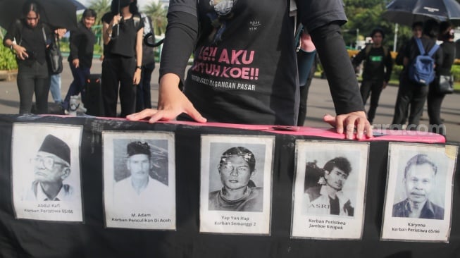 Para aktivis dari Jaringan Solidaritas Korban untuk Keadilan mengikuti Aksi Kamisan ke-862 di depan Istana Merdeka, Jakarta, Kamis (15/5/2025). [Suara.com/Alfian Winanto]
