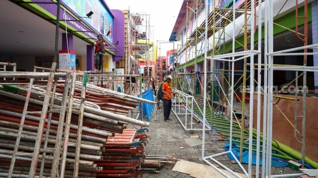 Pekerja menyelesaikan pembuatan gerai yang akan berpartisipasi dalam Jakarta Fair 2025 di JIExpo, Kemayoran, Jakarta, Rabu (18/6/2025). [Suara.com/Alfian Winanto]