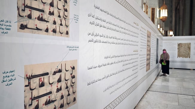 Pengunjung mengamati instalasi informasi pameran sejarah mushaf Al Quran di area perluasan ketiga Masjidil Haram di Makkah, Arab Saudi, Minggu (15/6/2025). [ANTARA FOTO/Andika Wahyu/tom]